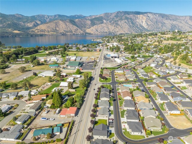 drone / aerial view featuring a water and mountain view