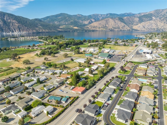 drone / aerial view with a water and mountain view