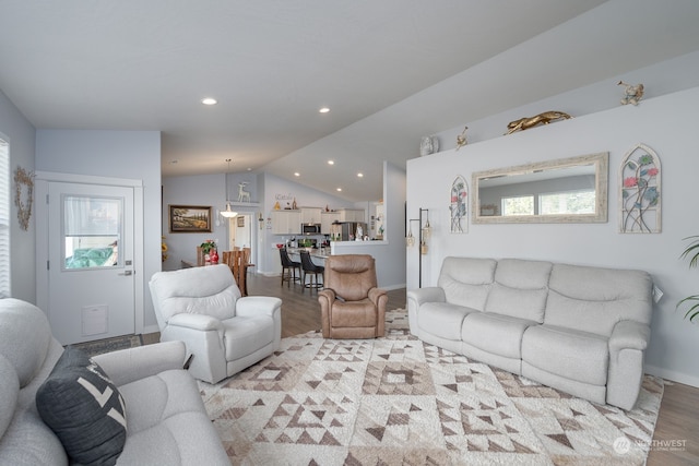 living room with light hardwood / wood-style floors and lofted ceiling