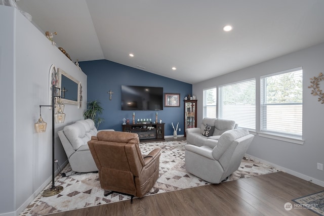 living room with light wood-type flooring and vaulted ceiling