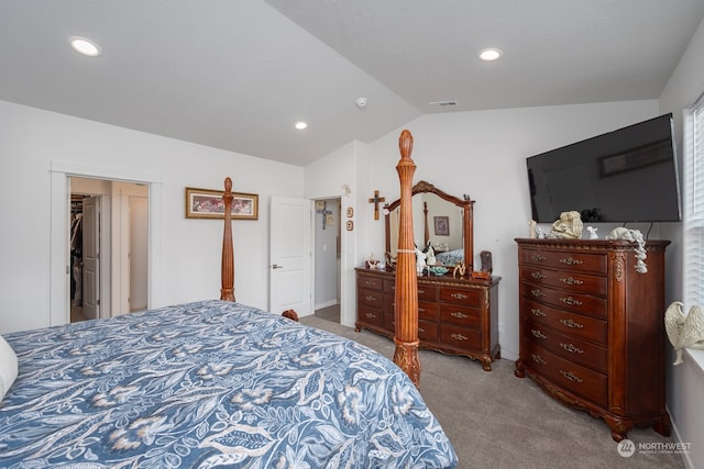 bedroom with vaulted ceiling and light carpet