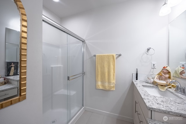 bathroom with vanity and a shower with door