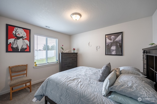 carpeted bedroom with a textured ceiling