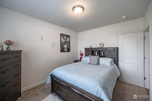 carpeted bedroom featuring a textured ceiling