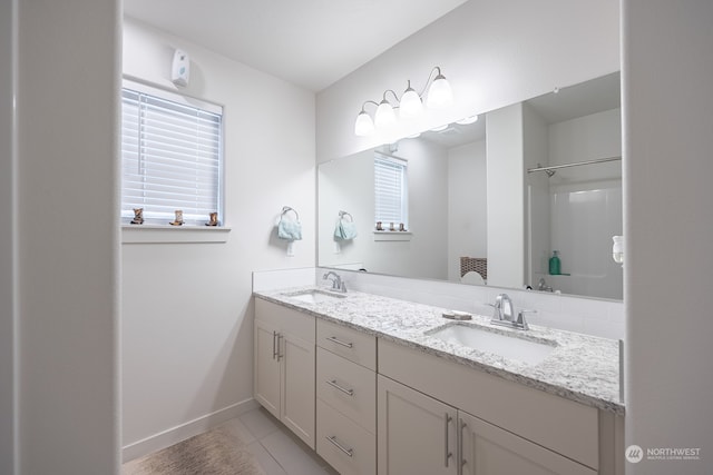 bathroom with vanity, walk in shower, and tile patterned floors