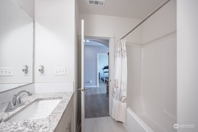 bathroom with vanity, shower / tub combo with curtain, and hardwood / wood-style floors