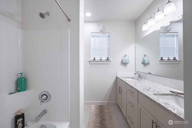 bathroom with vanity, tile patterned floors, and  shower combination