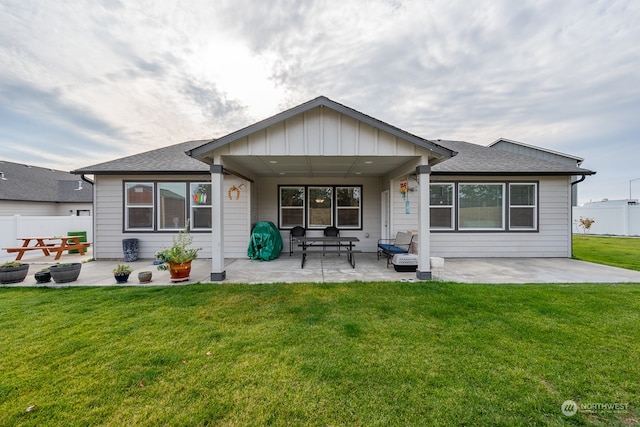 rear view of house with a yard and a patio area