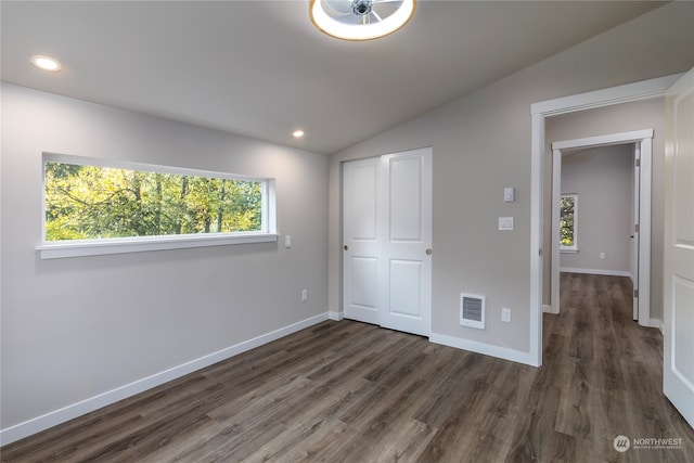 unfurnished bedroom with vaulted ceiling and dark hardwood / wood-style flooring