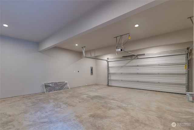 garage featuring a garage door opener and electric panel