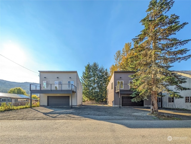 view of front of property with a mountain view and a garage