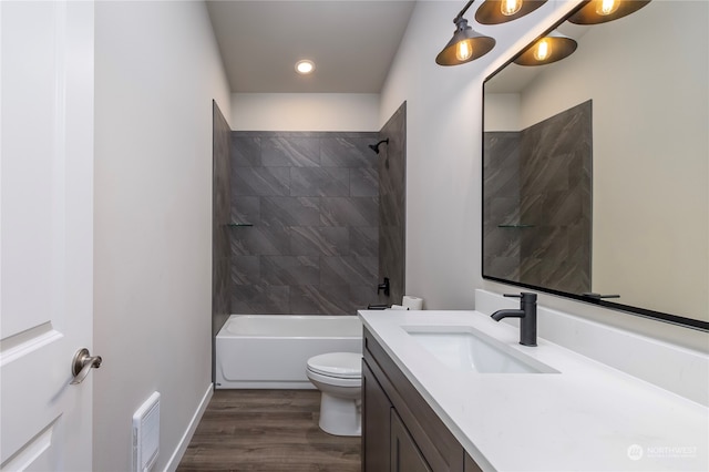 full bathroom featuring vanity, toilet, wood-type flooring, and tiled shower / bath