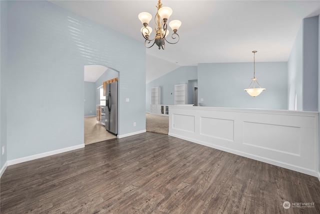 interior space featuring lofted ceiling, a chandelier, and dark hardwood / wood-style floors