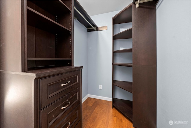 walk in closet with light wood-type flooring