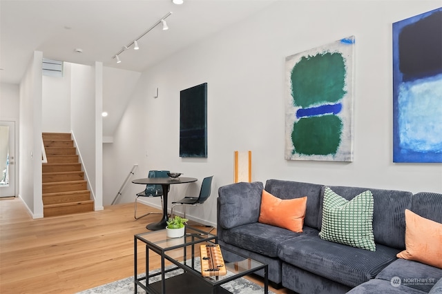 living room with hardwood / wood-style floors and rail lighting