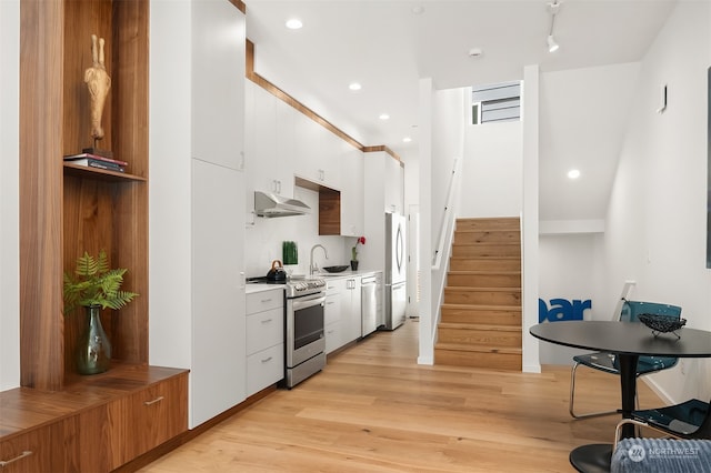 kitchen with white cabinets, sink, light wood-type flooring, and stainless steel appliances