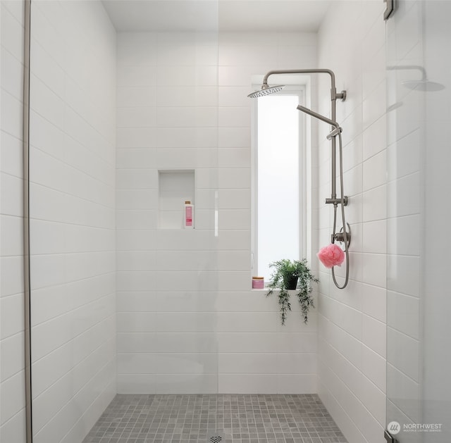 bathroom with tiled shower