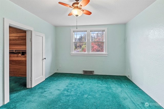 empty room with carpet and ceiling fan