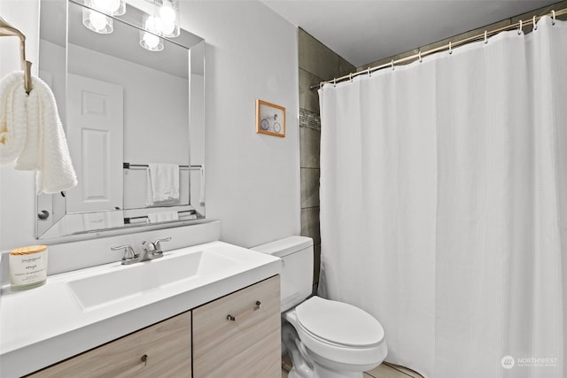 bathroom featuring toilet and vanity