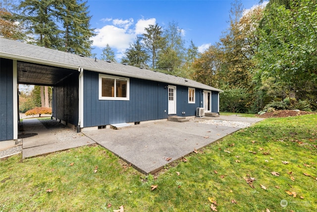 rear view of property with a patio and a yard