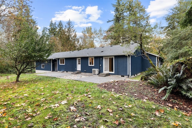 rear view of property featuring a patio and a yard