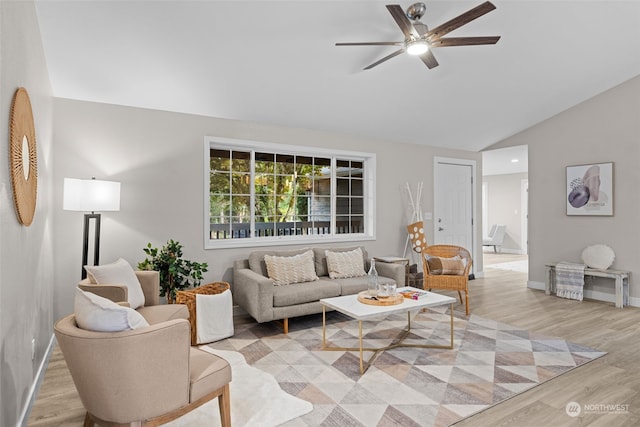 living room featuring light hardwood / wood-style flooring, ceiling fan, and vaulted ceiling