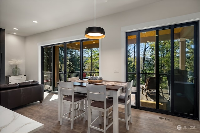 dining space with hardwood / wood-style flooring and plenty of natural light