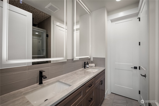 bathroom featuring vanity, tile patterned floors, and decorative backsplash