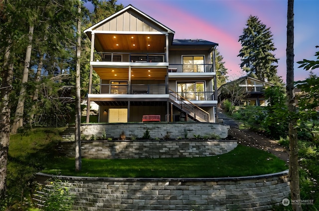 back house at dusk with a balcony