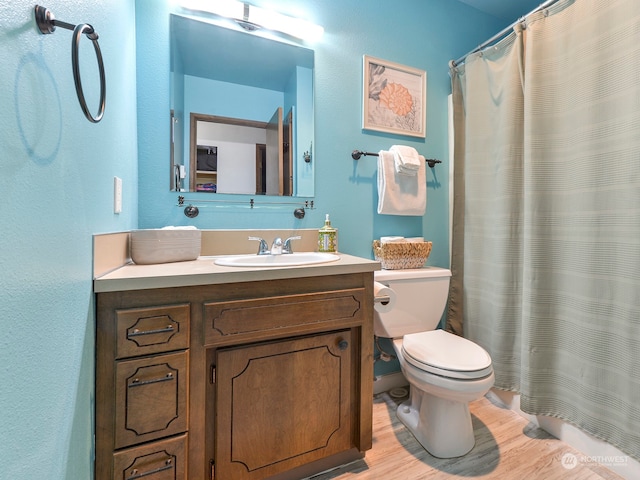 bathroom featuring vanity, hardwood / wood-style floors, a shower with curtain, and toilet