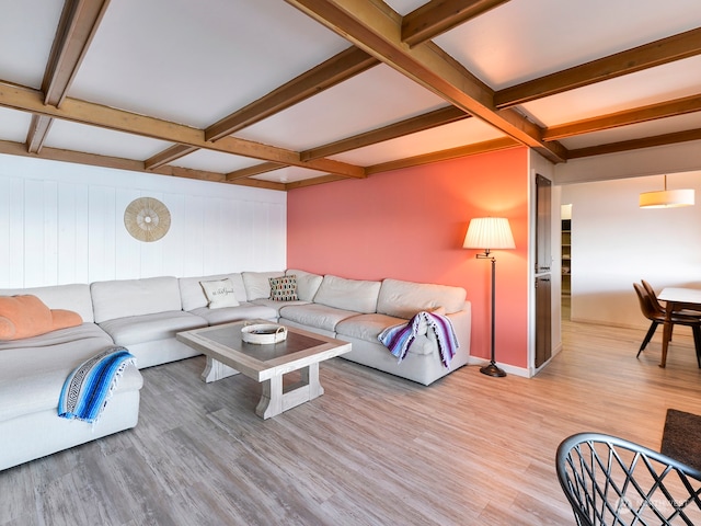 living room featuring beam ceiling, coffered ceiling, and light hardwood / wood-style flooring