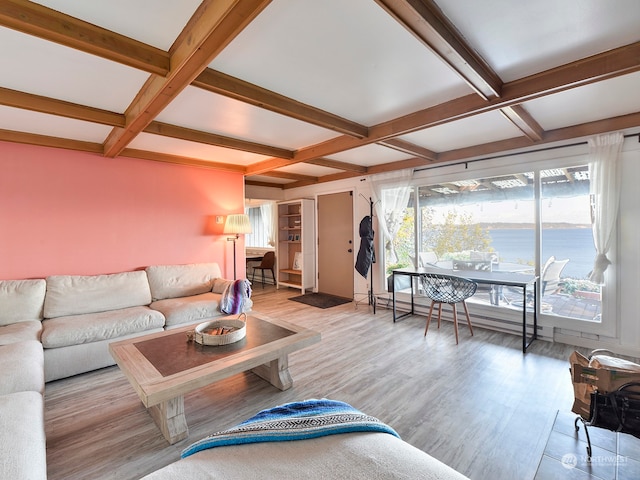 living room featuring light hardwood / wood-style floors, beamed ceiling, coffered ceiling, and a water view