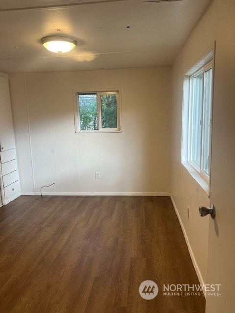 spare room featuring dark hardwood / wood-style flooring