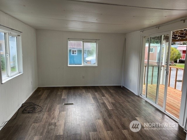 unfurnished room featuring dark wood-type flooring