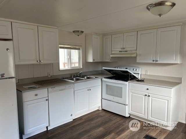 kitchen featuring white appliances, dark hardwood / wood-style flooring, sink, and white cabinets