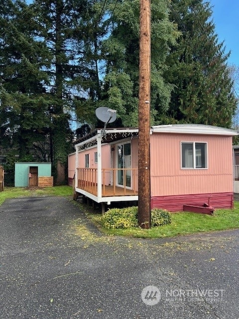 105 Cox Unit 4, Arlington, WA 98223 - view of property exterior with a wooden deck