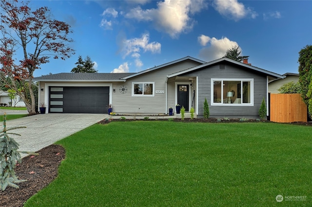 ranch-style house featuring a front lawn and a garage