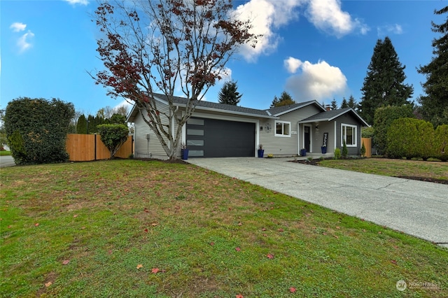 ranch-style home featuring a front lawn and a garage