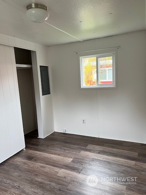 105 Cox Unit 12, Arlington, WA 98223 - unfurnished bedroom with electric panel, wood finished floors, and a closet