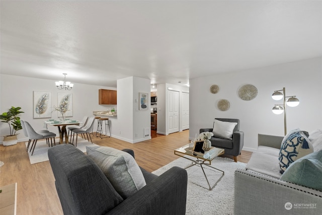 living room with a chandelier and light hardwood / wood-style flooring