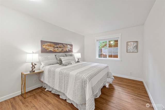 bedroom with hardwood / wood-style floors