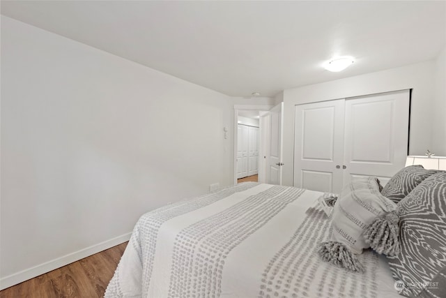 bedroom featuring hardwood / wood-style floors and a closet