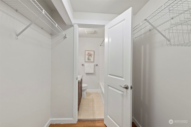 walk in closet with tile patterned flooring