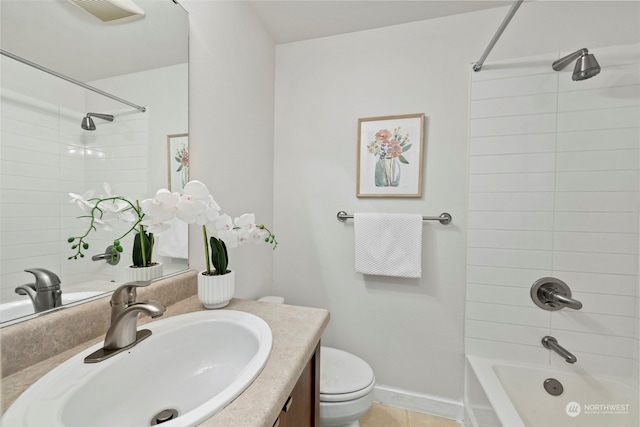 full bathroom featuring tiled shower / bath, vanity, toilet, and tile patterned flooring