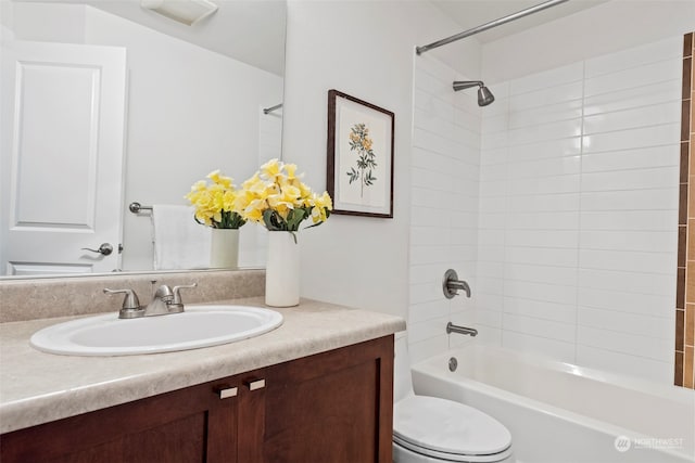 full bathroom with vanity, toilet, and tiled shower / bath combo