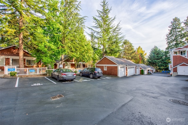 view of vehicle parking featuring a garage