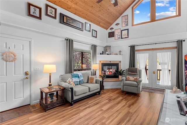 456 Hinthorne Ln, Leavenworth, WA 98826 - living area featuring light wood-style flooring, high vaulted ceiling, a tiled fireplace, a ceiling fan, and french doors