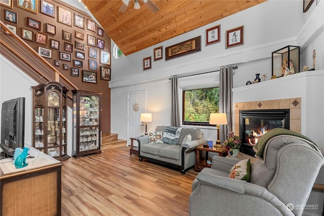 456 Hinthorne Ln, Leavenworth, WA 98826 - living room featuring light wood finished floors, a tiled fireplace, wooden ceiling, high vaulted ceiling, and ceiling fan