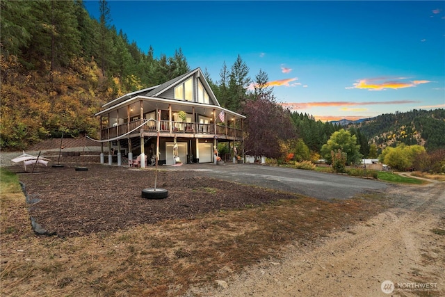 456 Hinthorne Ln, Leavenworth, WA 98826 - view of front of home featuring driveway, a garage, and a wooden deck