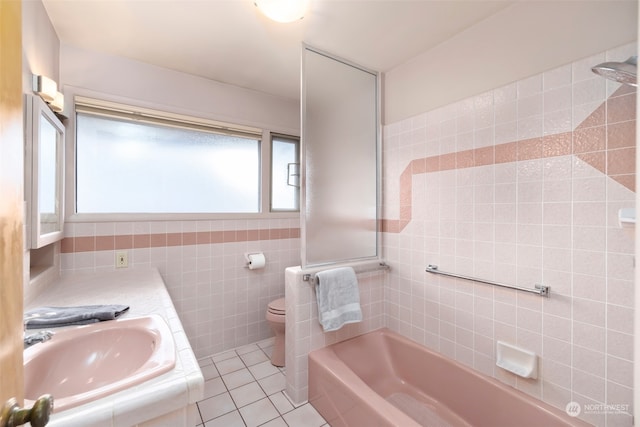 bathroom with tile patterned flooring, vanity, toilet, and tile walls